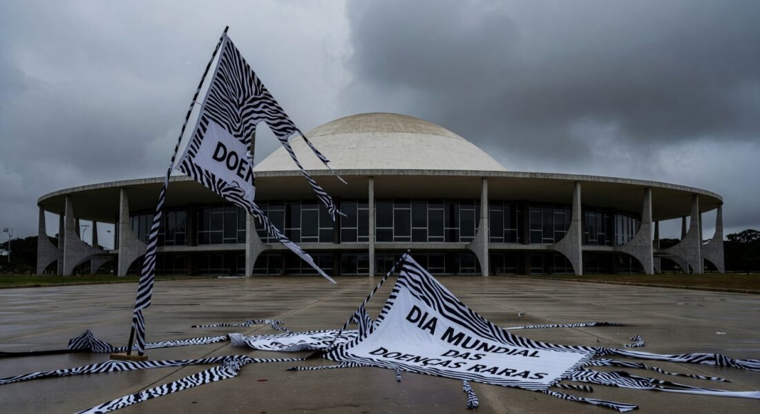 Fachada da CLDF com banners do Dia Mundial das Doenças Raras rasgados, expondo lacunas no apoio a pacientes.