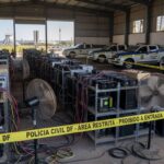Viaturas da Polícia Civil e equipamentos de mineração clandestina de criptomoedas em galpão no DF, operação da Neoenergia.