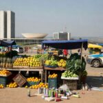 Viatura da Polícia Militar no DF perto de feira e ônibus após incidente com briga e spray de gás.