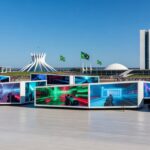 Vista ampla do evento TecnoGame 2026 em Brasília, com stands de tecnologia e games em centro de convenções moderno.